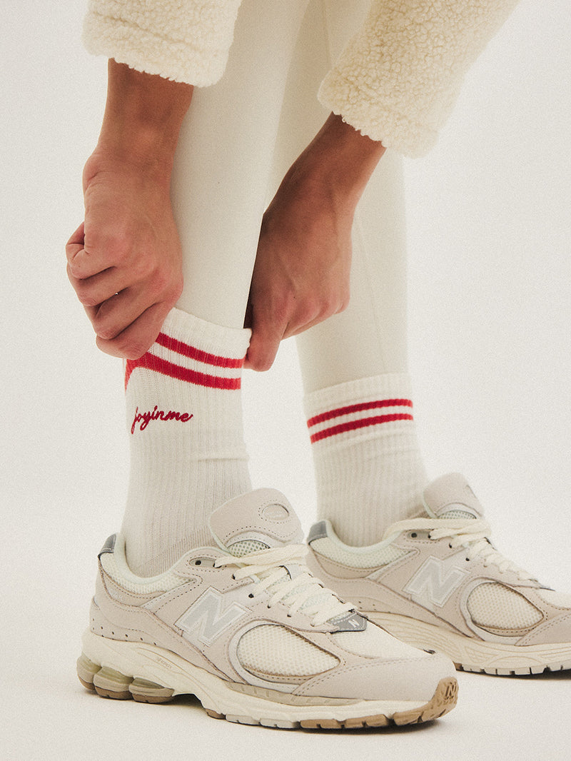 Białe skarpetki do jogi z czerwonymi paskami JOYINME - widok na haft z logo JOYINME